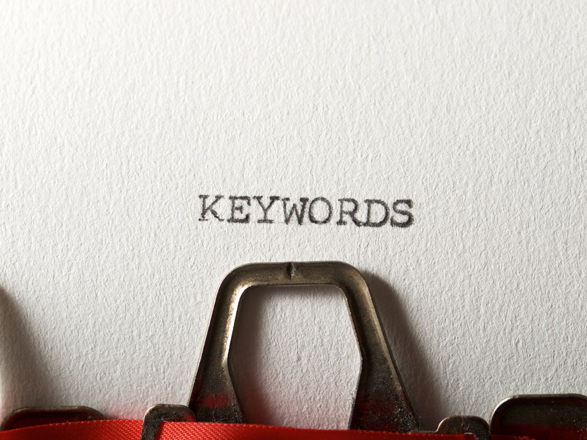 The word "KEYWORDS" typed on paper with a vintage typewriter.